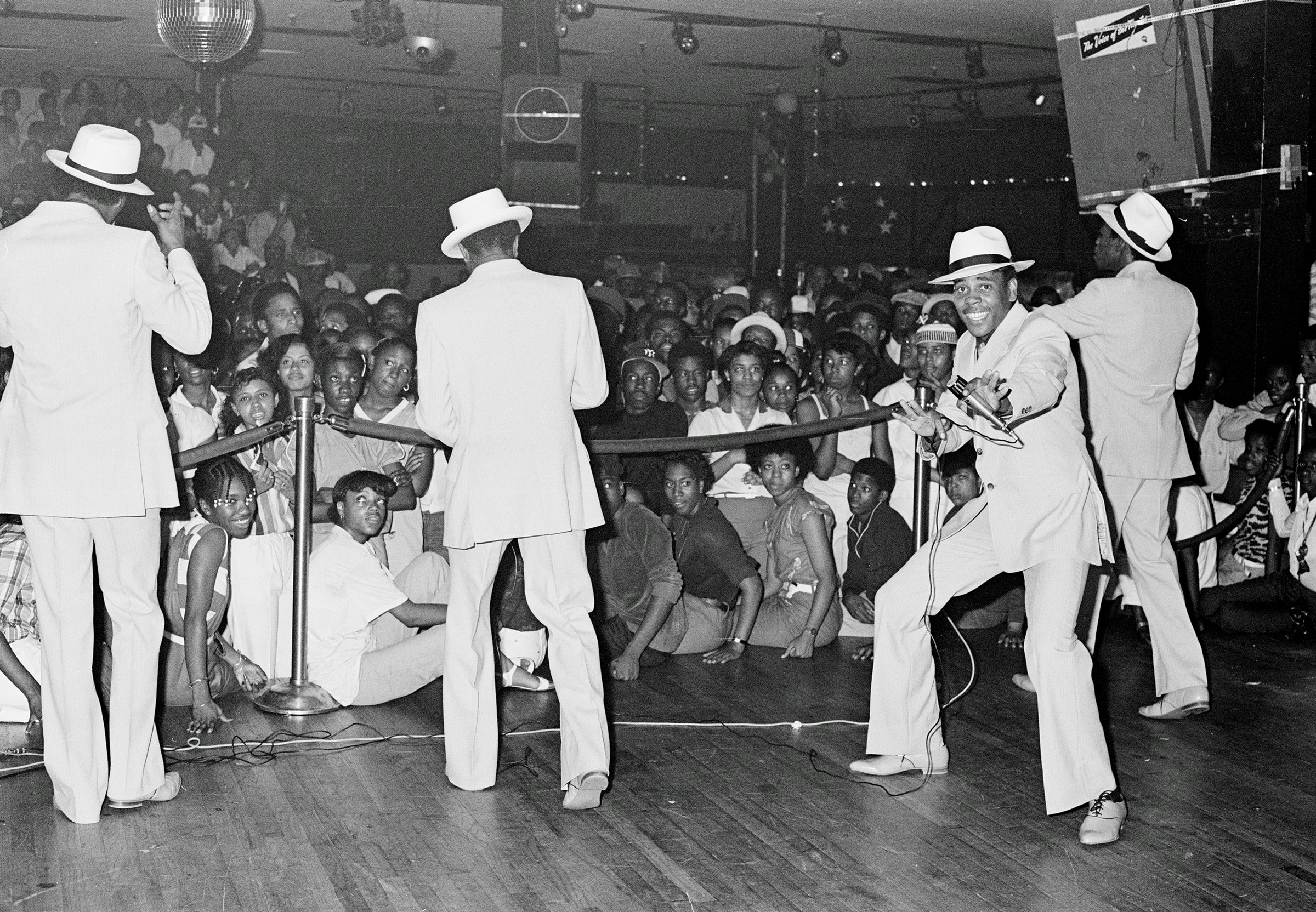 The Cold Crush Brothers onstage at “The Battle” against the Fantastic Romantic 5 on July 3, 1981. In the crowd, Sweet and Sour, an early female MC down with Kool Herc’s crew, the Herculoids, can be seen directly above the lefthand rope pedestal. Photo by Joe Conzo.